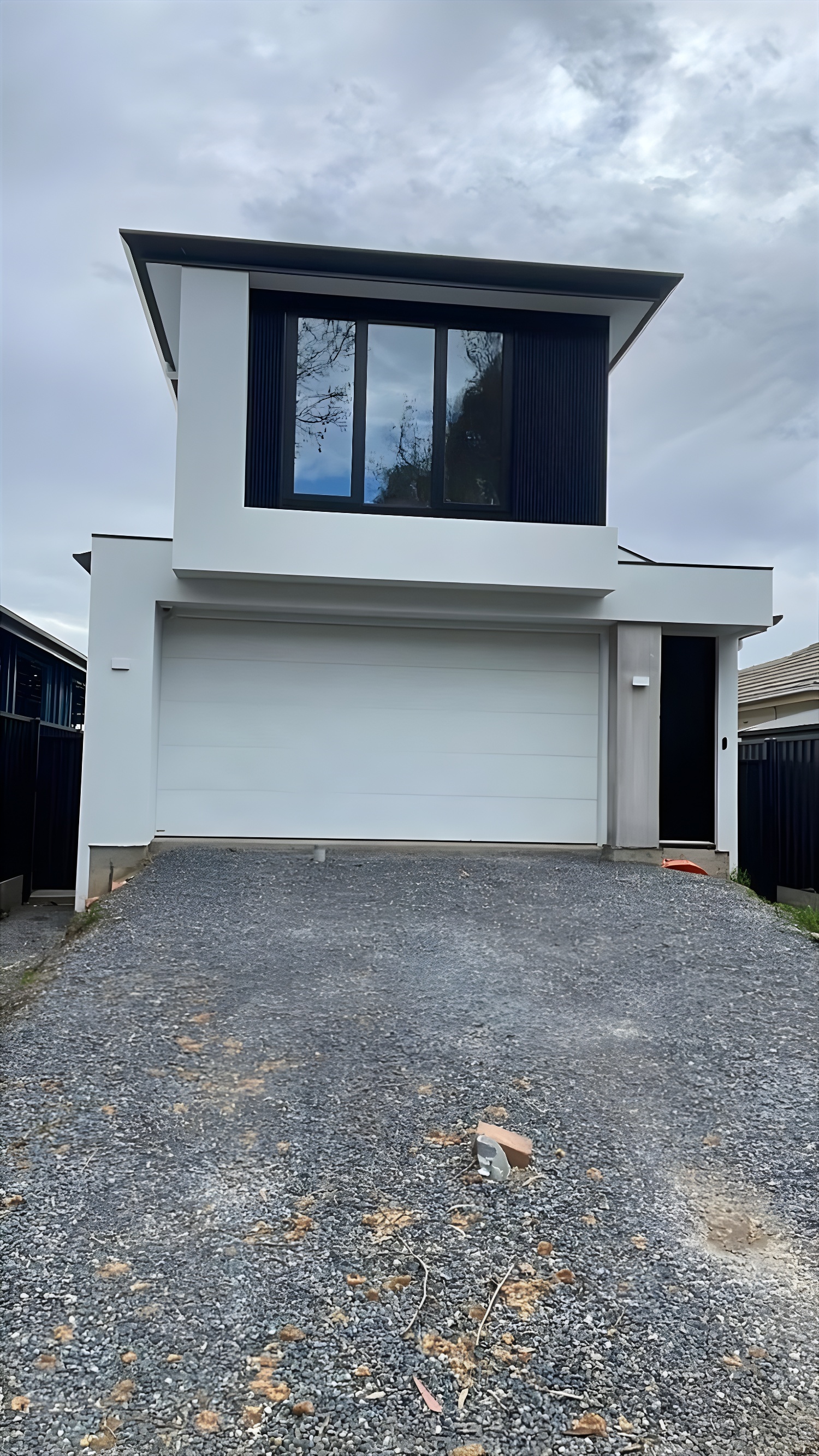 Modern two-storey home with rendered finish and feature cladding